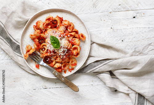 South italian  pasta orecchiette with tomato sauce and cacioricotta cheese photo