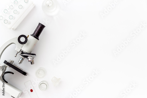Clinical science research with microscope. Laboratory equipment on white background top view copy space