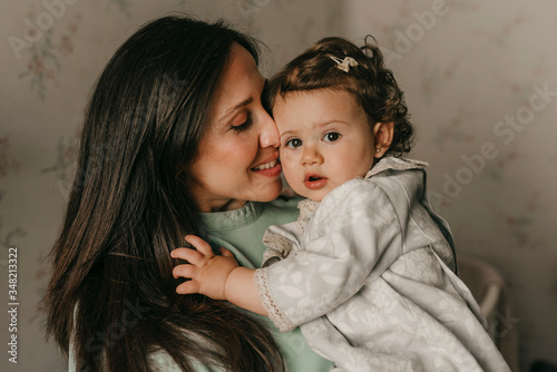 pretty young mother with her little daughter in the room