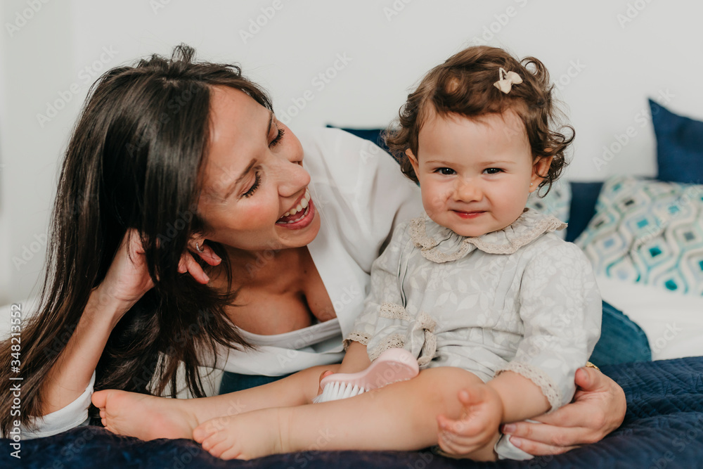 young pretty mother plays with her daughter young pretty mother plays with her daughter