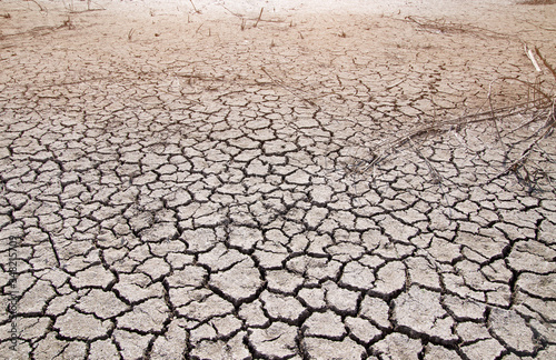 Canvas-taulu Dried clay soil with large cracks in hot weather
