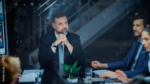 Photography Corporate Meeting Room: Charismatic Director Decisively Leans on a Conference Ta