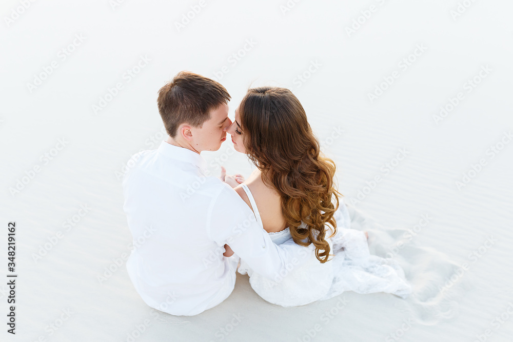 groom hugging bride in the desert at sunset groom hugging bride in the desert at sunset