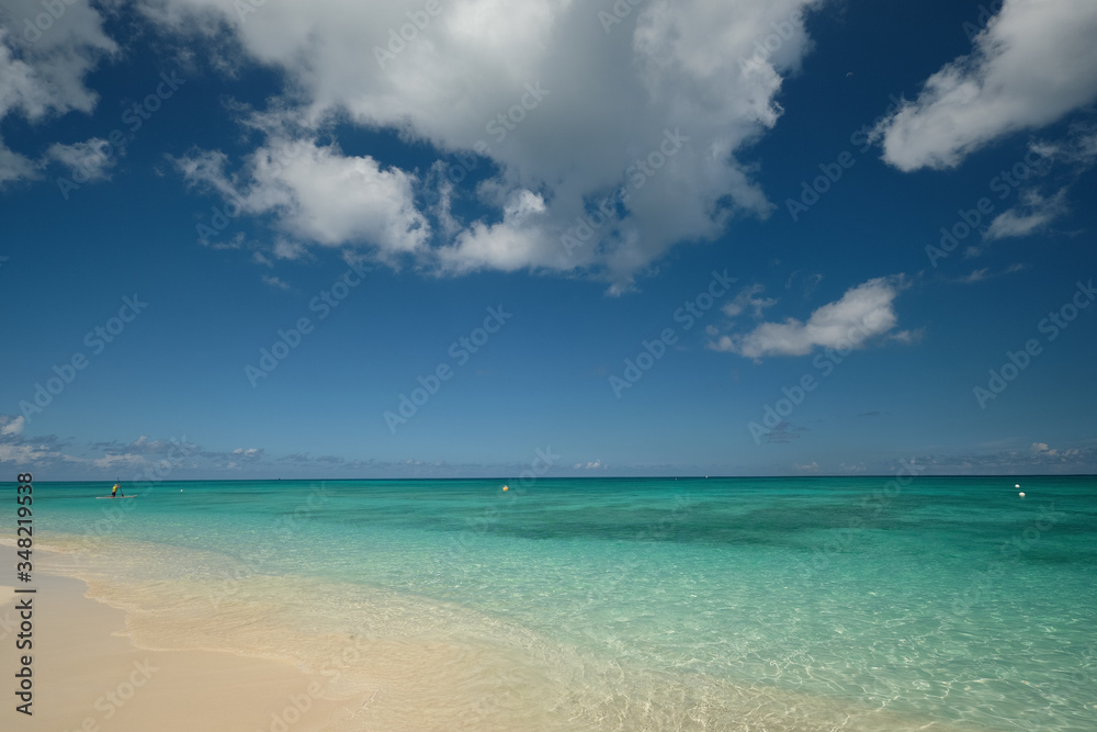 Crystal clear waters and pinkish sands on empty seven mile beach on tropical carribean Grand Cayman Island Crystal clear waters and pinkish sands on empty seven mile beach on tropical carribean Grand Cayman Island