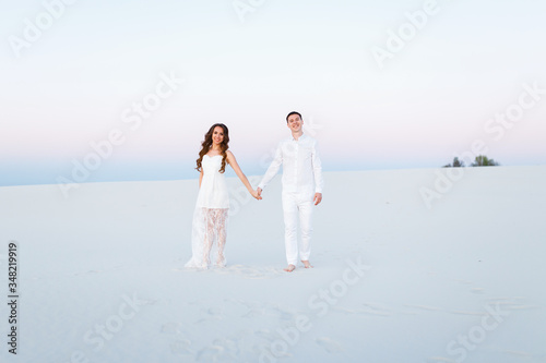 Newlyweds on a white desert island © Parfenova