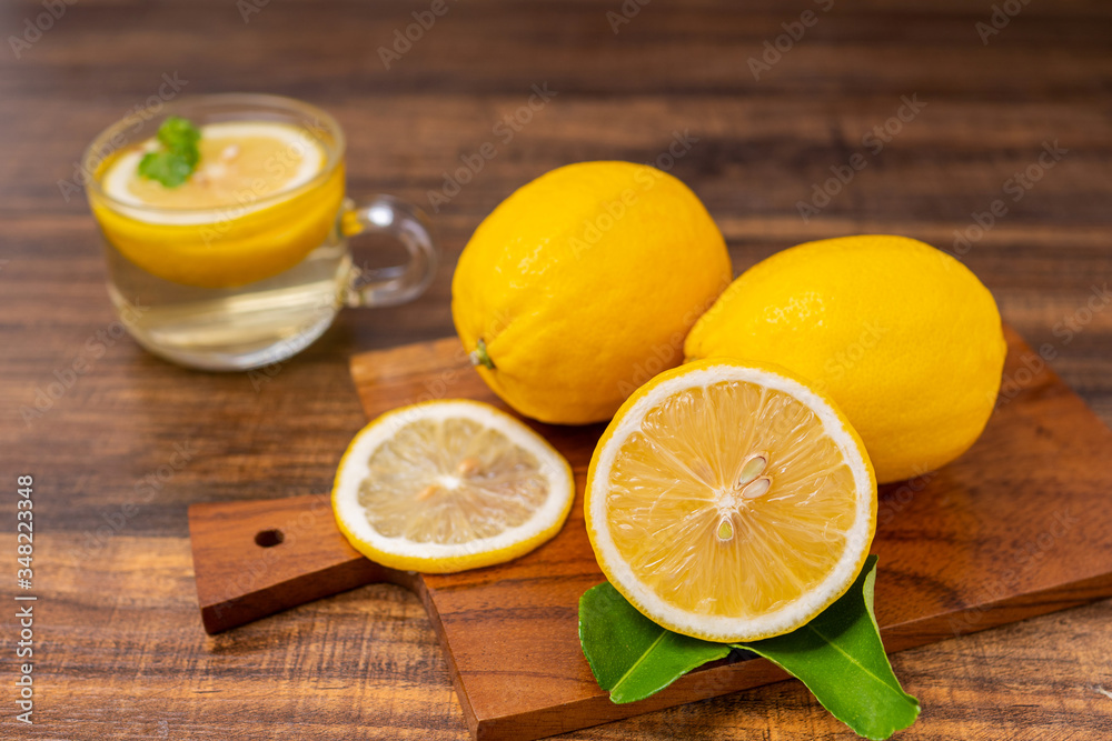 Fresh lemonade drinking with herb in glass, lime or mojito cocktail with lemon on wood table for copy space in hot summer Fresh lemonade drinking with herb in glass, lime or mojito cocktail with lemon on wood table for copy space in hot summer