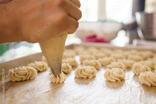 semprit cake. asian bite sized dessert. piping some dough kue sepirit photo