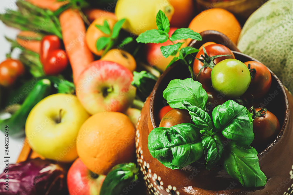 rustic composition of fruit and vegetables with basil in the foreground inside a typical Mexican terracotta pot rustic composition of fruit and vegetables with basil in the foreground inside a typical Mexican terracotta pot