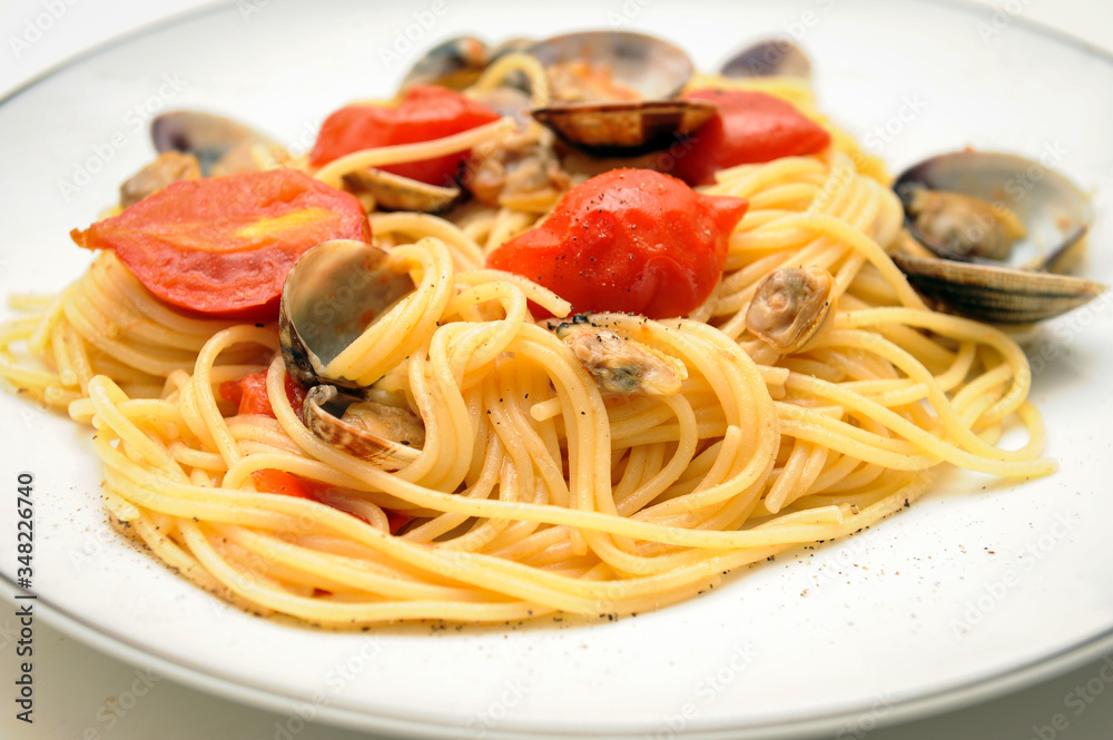 spaghetti dish with seasoning of Piennolo tomatoes from Campania and clams