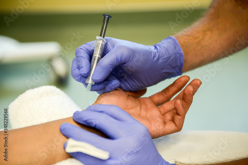 A Respiratory Therapist is preparing to perform an arterial blood gas puncture to collect arterial blood for analysis and diagnosis of cardio-pulmonary abnormalities. photo