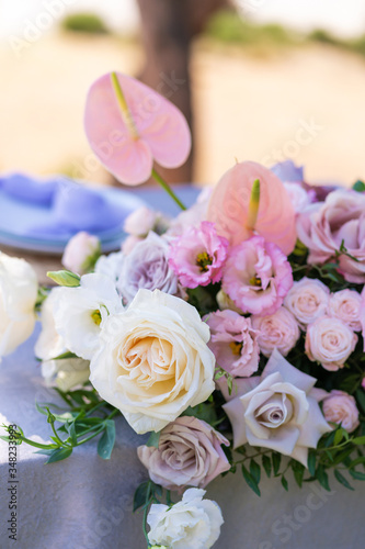 Bouquets of fresh flowers decoration of the festive table. Celebrating an open air party. Decor Details