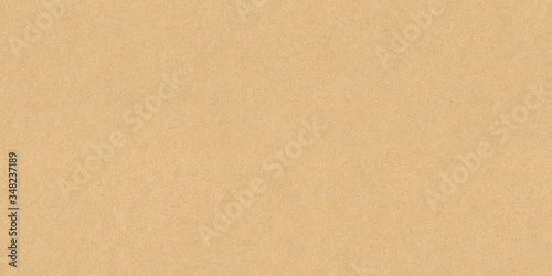 High resolution seamless yellow cardboard background or texture hard paper sheet. Beige recycled eco carton paper or seamless carton background. Yellow paperboard texture. photo