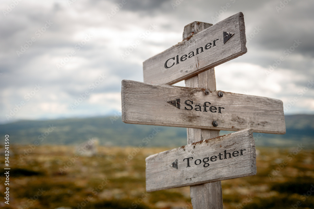 cleaner safer together text engraved on old wooden signpost outdoors in nature. Quotes, words and illustration concept.