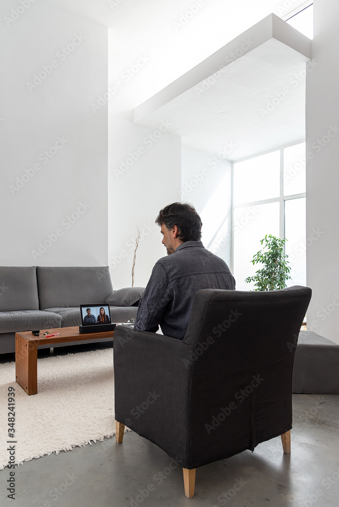 Man working at home and having a business videoconference at her home Man working at home and having a business videoconference at her home