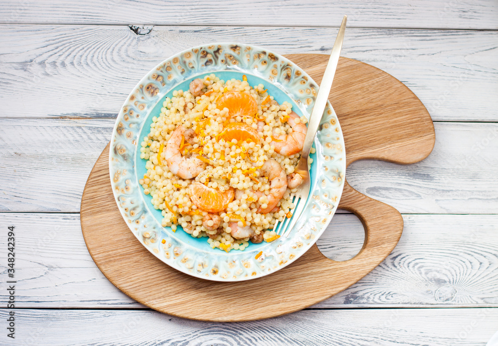 Healthy quinoa salad with fruits, vegetables and shrimps. Top view. Wooden background. Healthy quinoa salad with fruits, vegetables and shrimps. Top view. Wooden background.