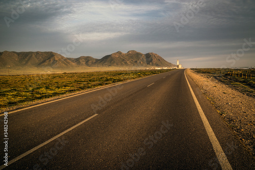 The deserted road to Las Salinas salt flats before sunset, Cabo de Gata-Níjar Natural Park, Almería province, Andalusia, Spain