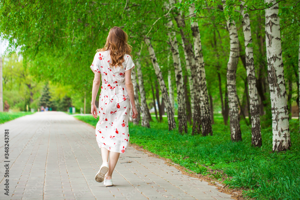 Portrait of a young beautiful blonde woman in white flowers dress Portrait of a young beautiful blonde woman in white flowers dress