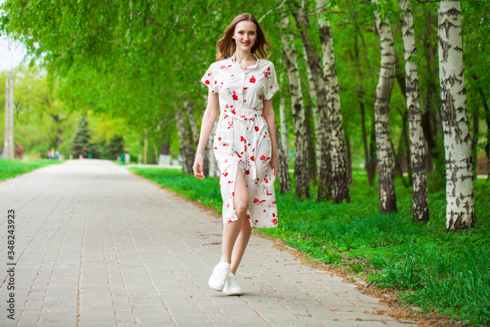 Portrait of a young beautiful blonde woman in white flowers dress Portrait of a young beautiful blonde woman in white flowers dress