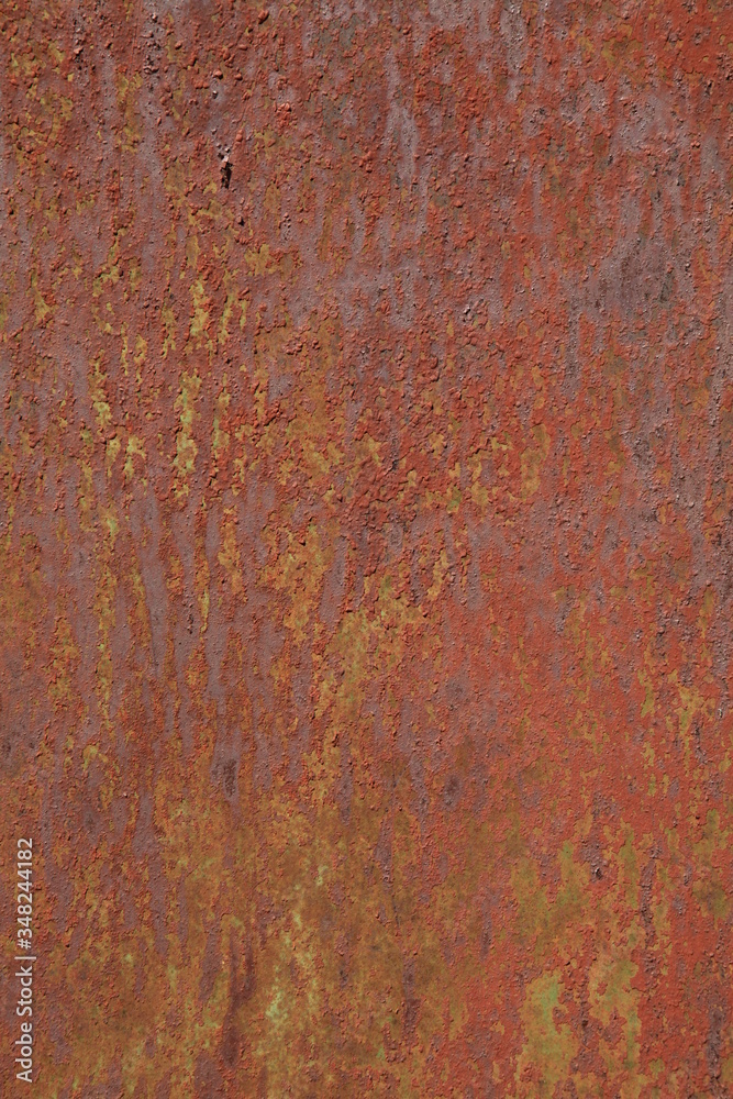 Rusted metallic wall background, texture. An old brown and rusty surface with faded uneven color. Abstract rust pattern on a fulvous (lurid) surface. The wall and fence sketches and colors