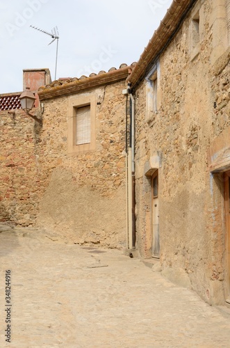 Lonely cobbled alley in Girona village
