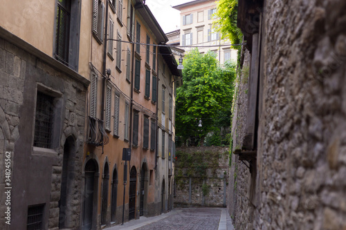 Traditional narrow Italian street and no people in Bergamo historical center  Italy. Medieval buildings. There s no one on the street.
