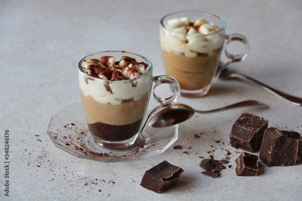 two coffee cream glass cups with cocoa powder two coffee cream glass cups with cocoa powder