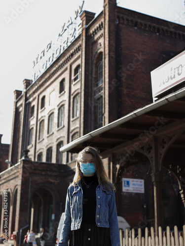 Girl with mask on the train station © Jakub