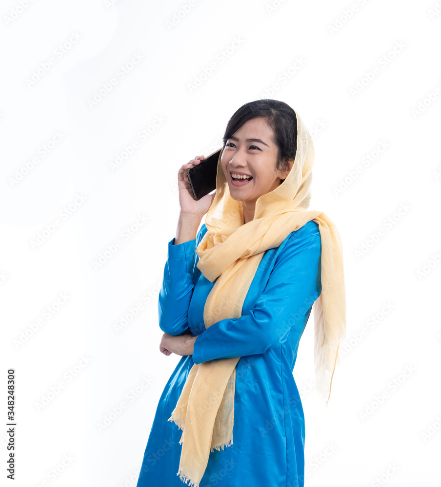 muslim young woman using mobile phone over white background muslim young woman using mobile phone over white background