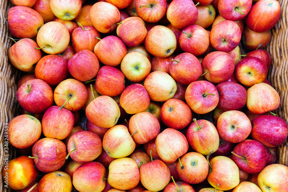 Red apples on the market counter. Apples in wooden boxes on the grocery shelf. Close up. Red apples on the market counter. Apples in wooden boxes on the grocery shelf. Close up.