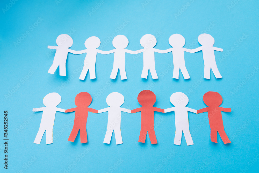 White and red paper people holding hands. Blue background White and red paper people holding hands. Blue background