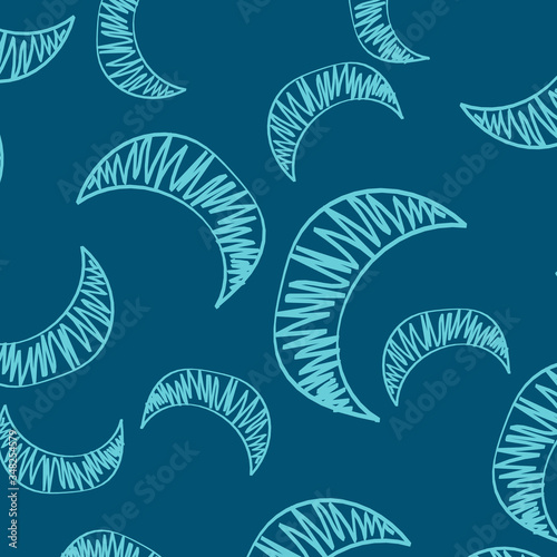 The seamless pattern of manually drawn crescents. The blue crescent is chaotically scattered across the blue field to form a beautiful pattern for children's room wallpaper or wrapping paper.
