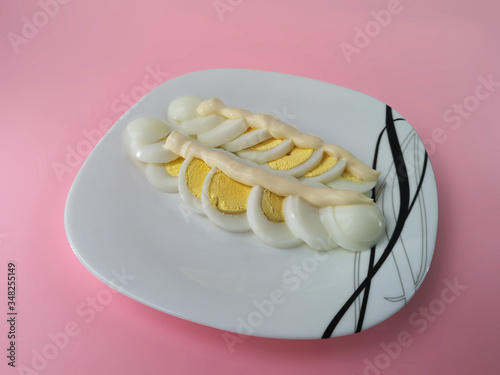 egg under mayonnaise on a plate