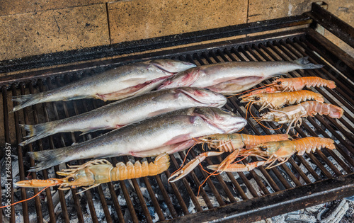 Fresh Seabasses and shrimp on a charcoal grill. photo