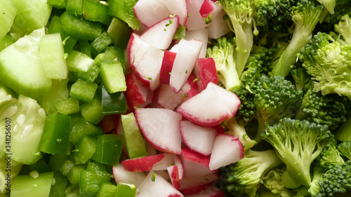 Close Up of Chopped Broccoli, Cucumbers, Radish and Peppers, Chopped Assortment of Vegetables in Natural Lighting, Fresh Vegetables photo