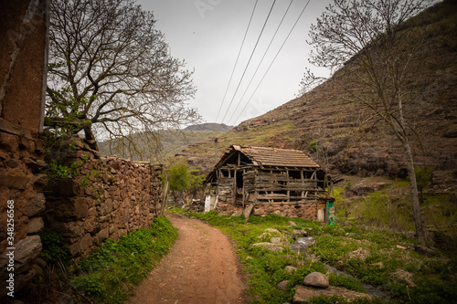 Old rustic idyllic houses in a village Topli do on Old Mountain (stara planina) in Serbia photo