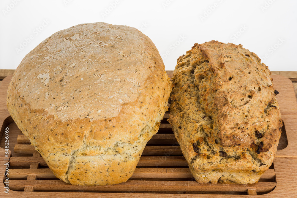 Two home made bread loafs one with chia seeds and other with onions and beef. Two home made bread loafs one with chia seeds and other with onions and beef.