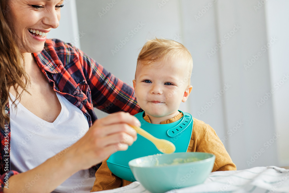 mother feeding baby food child eating family care childhood cute spoon mother feeding baby food child eating family care childhood cute spoon