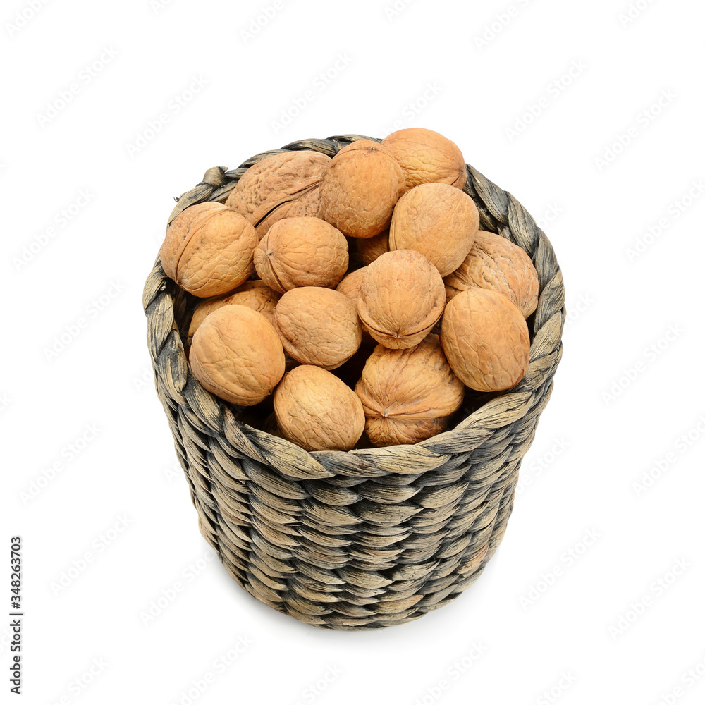 wicker basket with walnuts isolated on a white background. wicker basket with walnuts isolated on a white background.