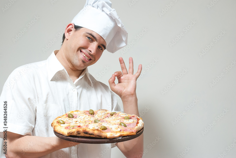 portrait cook with pizza on a light background portrait cook with pizza on a light background
