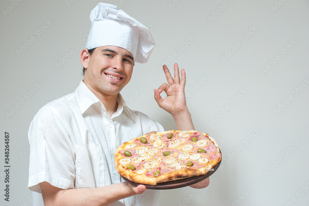 portrait cook with pizza on a light background portrait cook with pizza on a light background