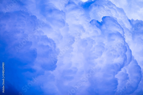 white and blue cumulus fluffy sunset cloud in the sky