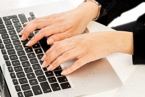 Closeup on the hands of a businesswoman working with notebook