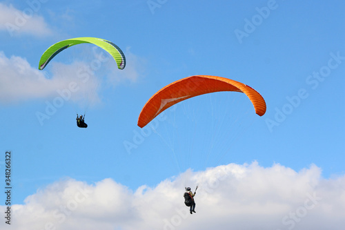 Paragliders flying wing in a blue sky 