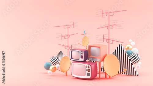 Fotografie The television is surrounded by antennas and satellite dishes on a pink background