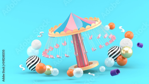 fairground rides surrounds many colorful balls on a blue background.-3d rendering.. photo
