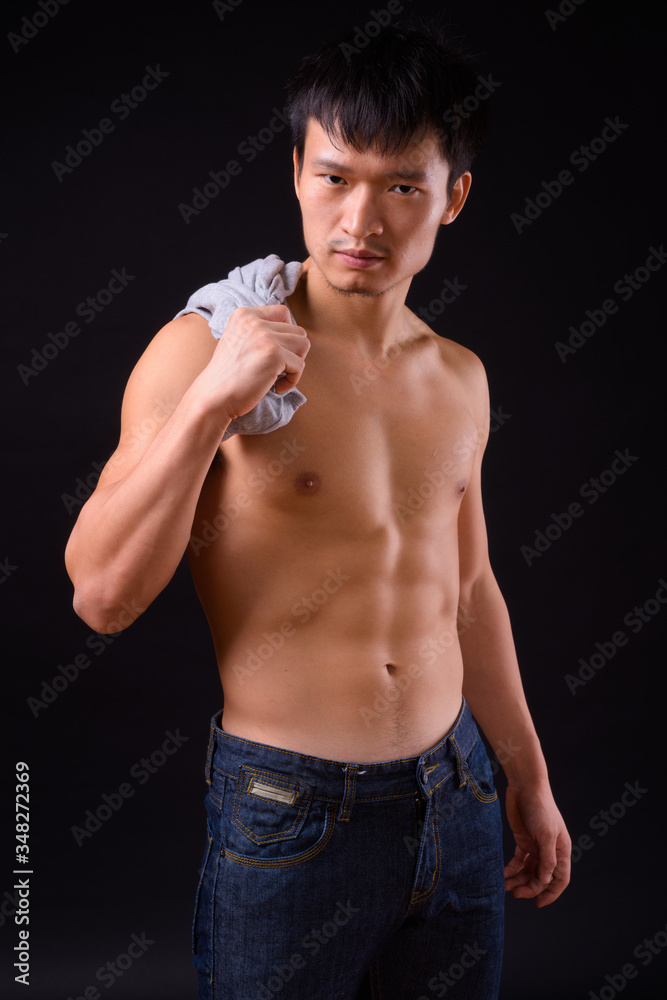 Portrait of young muscular Asian man shirtless