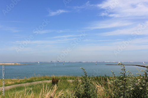 Fototapeta Naklejka Na Ścianę i Meble -  Mouth of the Scheldt River with the city of Vlissingen in the background during summer