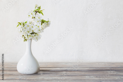 cherry flowers in vase on white background