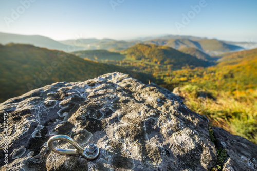 Top of the climbing outdoor wall and bolt in the rock in mountain