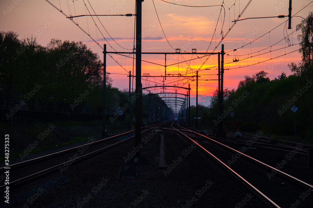 Sunset sky at over the railroad with reflective rails